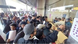 A passenger waiting for a flight at Amausi Airport died after his health deteriorated; his wife said she was not helped.